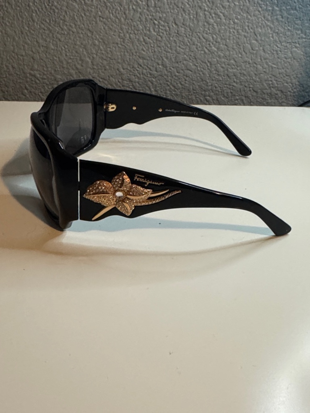 Salvatore Ferragamo Black Sunglasses with Rose Gold Floral Emblem